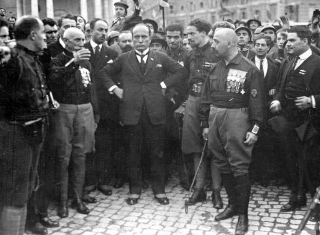Italian Fascist leader Benito Mussolini, centre, hands on hips, with members of the fascist Party, in Rome, Italy, October 28, 1922, following their March on Rome. Following the march King Emanuelle III asked Mussolini to form a new government. (Photo by AP Photo)