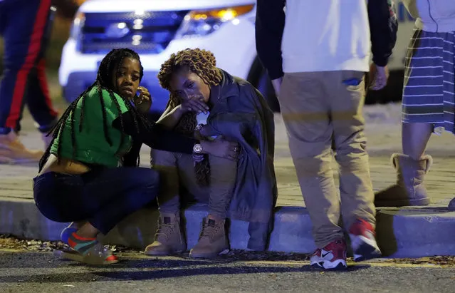 A woman is comforted as police investigate the scene of a Mardi Gras day shooting that left at least one dead and others injured, in the lower ninth ward in New Orleans, Tuesday, February 13, 2018. (Photo by Gerald Herbert/AP Photo)