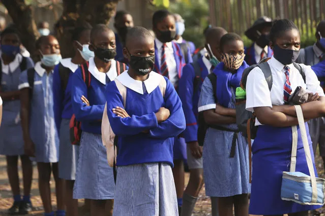 Schoolchildren wait to enter their school in Harare, Zimbabwe, Monday September 28, 2020. Zimbabwe schools have reopened in phases, but with smaller number of pupils, more teachers and other related measures to enable children to resume their education without the risk of a spike in COVID-19 infections. (Photo by Tsvangirayi Mukwazhi/AP Photo)