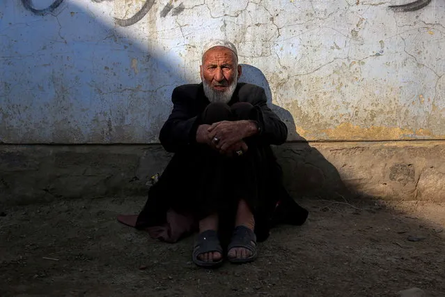 A man rests in partial sunlight in Kabul as extreme cold weather grips the country, Afghanistan, 19 January 2023. Dozens of people and tens of thousands of cattle have died because of the freezing temperatures and food shortages. (Photo by EPA/EFE/Stringer)