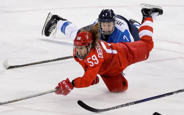 Olympic Athlete from Russia Yelena Dergachyova (59) falls to the ice with Mira Jalosuo of Finland in the women' s preliminary round ice hockey match between Finland and Olympic Athletes from Russia during the Pyeongchang 2018 Winter Olympic Games at the Kwandong Hockey Centre in Gangneung on February 15, 2018. (Photo by David W. Cerny/Reuters)
