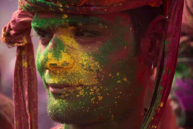 Indians celebrate Holi, the spring festival of colours, during a traditional gathering at Nandbaba temple in Nandgaon village of Mathura district in Uttar Pradesh, India on February 25, 2018. Holi is observed in India at the end of the winter season on the last full moon of the lunar month. (Photo by Javed Sultan/Anadolu Agency/Getty Images)