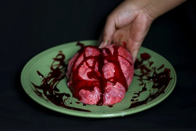 A bloody brain made of gummy candy and red jelly is pictured at the Zombie Gourmet homemade candy manufacturer on the outskirts of Mexico City October 30, 2015. (Photo by Carlos Jasso/Reuters)