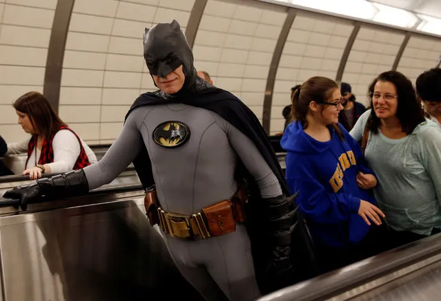 A man dressed in costume rides the subway escalator enroute to the New York Comic Con with other commuters in New York, U.S., October 6, 2016. (Photo by Shannon Stapleton/Reuters)
