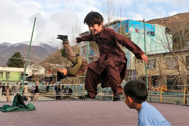 Children jump on a trampoline in Fayzabad district of Badakhshan province on February 6, 2023. (Photo by Omer Abrar/AFP Photo)
