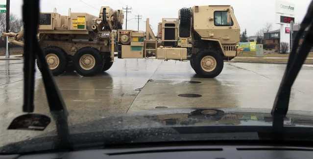 A view motorists have grown accustomed seeing, a military truck made by Oshkosh Corp. is taken for a test drive Thursday, April 11, 2013 in Oshkosh, Wis. Faced with deep cuts in U.S. military spending, and the end of the wars in Iraq and Afghanistan, Oshkosh Corp. is laying off 900 employees in its defense division based in Oshkosh. Approximately 700 hourly workers at the state's largest manufacturer will lose their jobs in mid-June, followed by approximately 200 salaried employees through July. (Photo by Mark Hoffman via The Journal Sentinel)