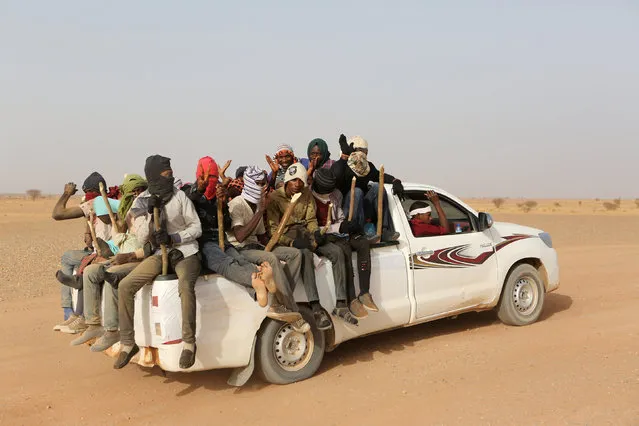Migrants crossing the Sahara desert into Libya sit on the back of a pickup truck outside Agadez, Niger, May 9, 2016. (Photo by Joe Penney/Reuters)