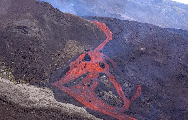 A picture taken on February 10, 2020, shows lava oozing down the Piton de le Fournaise volcano during an eruption, on the French Indian Ocean island of La Reunion. The eruption in the first of 2020. Located in the southeast of Reunion Island, the Piton de la Fournaise is one of the most active volcanoes in the world. (Photo by Richard Bouhet/AFP Photo)