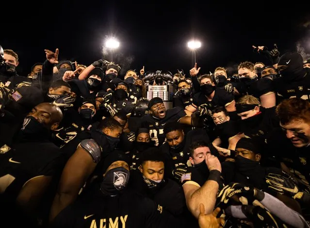 The Army Black Knights pose with the Commander-in-Chief's Trophy after defeating the Air Force Falcons 10-7 at Michie Stadium on December 19, 2020 in West Point, New York. (Photo by Dustin Satloff/Getty Images)