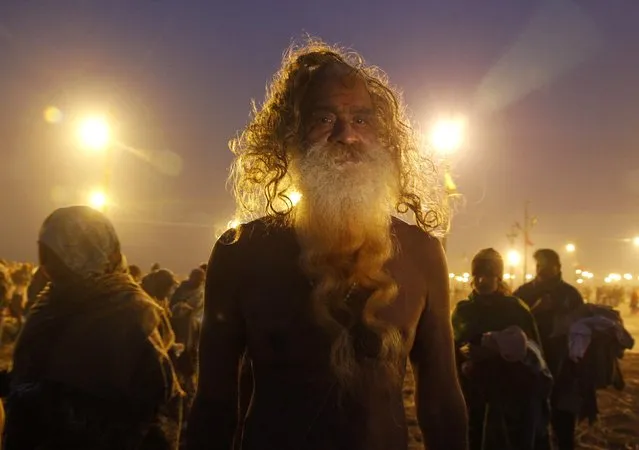 A Sadhu or a Hindu holyman arrives to take a holy dip at Sangam during Magh Mela in the northern Indian city of Allahabad January 5, 2015. The festival is an annual religious event held during the Hindu month of Magh, when thousands of devotees take a holy dip in the waters of Sangam, the confluence of the Ganges, Yamuna and Saraswati rivers. (Photo by Jitendra Prakash/Reuters)