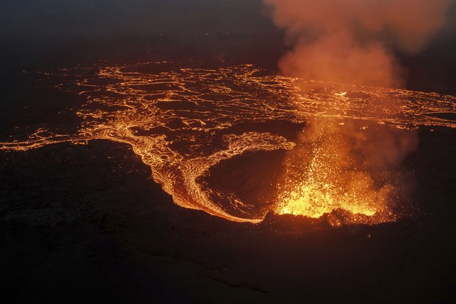 Lava flows next to the northern crater after a volcanic eruption around 6 kilometers (3.7 miles) north of Grindavik, Iceland, on the Reykjanes Peninsula, Saturday, July 19, 2025. (Photo by Marco di Marco/AP Photo)