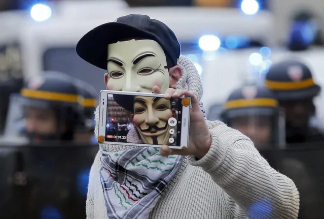 An activist takes a selfie during a protest ahead of the 2015 Paris Climate Conference, in Paris, Sunday, November 29, 2015. (Photo by Christophe Ena/AP Photo)