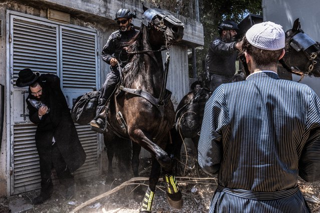 Ultra-Orthodox men clash with police at the Tel Hashomer military recruitment office in Kiryat Uno, Israel on August 5, 2024, as they protest the start of the military draft for members of the Haredi community. (Photo by Heidi Levine for The Washington Post)