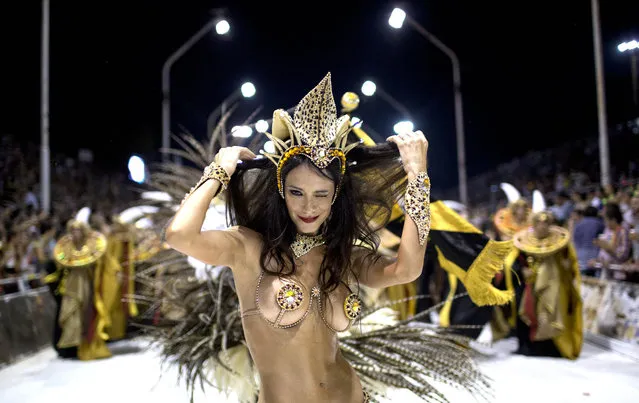 Evangelina Carrozo, a dancer with the Ara Yevi samba school, performs during a carnival parade in tribute to Pope Francis in Gualeguaychu, Argentina, early Sunday, January 11, 2015. The troupe's main song says: “We're the power of a revolution, let's make noise, it's carnival”, quoting the Argentine Pontiff's famous call to “make noise” to the crowd during his 2013 visit to Brazil. (Photo by Natacha Pisarenko/AP Photo)