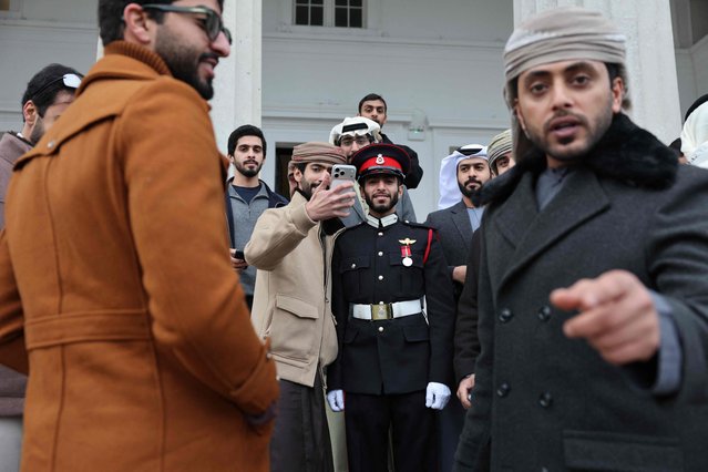 Officer Cadet Almansoori (C) from the UAE poses with family members after the No. 251 Sovereign�s Parade, at the Royal Military Academy in Sandhurst, southwest of London on December 12, 2025. The parade marks the completion of 44 weeks of intensive training for the Officer Cadets of Commissioning Course 251. (Photo by Adrian Dennis/AFP Photo)