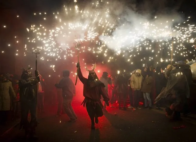 A reveller wearing a demon costume takes part in the traditional festival of “Correfoc” in Palma de Mallorca, on January 17, 2015. (Photo by Jaime Reina/AFP Photo)