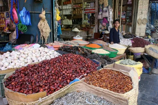 A vendor waits for customers at his spice shop in Yemen's southwestern city of Taiz, Yemen November 20, 2015. (Photo by Anees Mahyoub/Reuters)