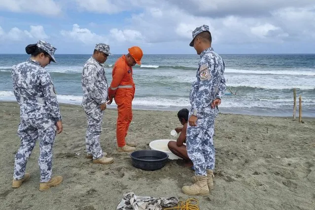 In this handout photo provided by the Philippine Coast Guard, Philippine Coast Guard personnel check on a fisherman while conducting patrol along shore lines in Ilocos Norte province, northern Philippines, as they prepare for the possible effects of Typhoon Mawar on Monday, May 29, 2023. Philippine officials began evacuating thousands of villagers, shut down schools and offices and imposed a no-sail ban Monday as Typhoon Mawar approached the country's northern provinces a week after battering the U.S. territory of Guam. (Photo by Philippine Coast Guard via AP Photo)