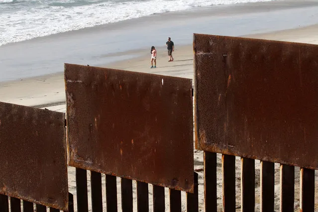 Tourists in San Diego, California, U.S. are seen behind a fence separating Mexico and the United States November 12, 2016. Picture taken from Tijuana, Mexico. (Photo by Jorge Duenes/Reuters)