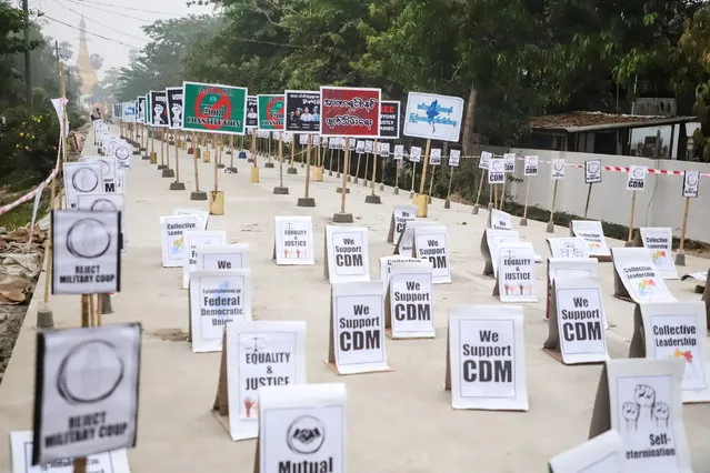 View of signs during a protest without demonstrators present in Nyaungdon, Ayeyarwady, Myanmar on March 14, 2021 in this image taken from social media. (Photo by Ayeyarwaddy Karen Youth Seminar via Reuters)