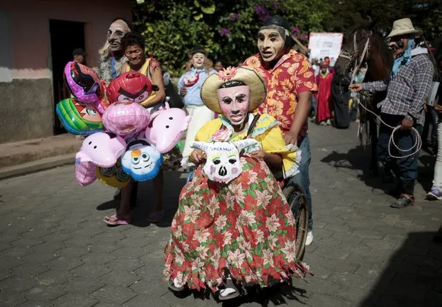 People wearing masks and dressed in traditional costume take part in a festival honouring San Silvestre, in the town of Catarina, Nicaragua January 1, 2016. (Photo by Oswaldo Rivas/Reuters)