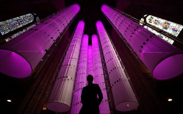 Artist Peter Walker stands in front of his installation 'Identity – We Are All Together' in the Anglican Cathedral in Liverpool, Britain on July 28, 2023. (Photo by Phil Noble/Reuters)