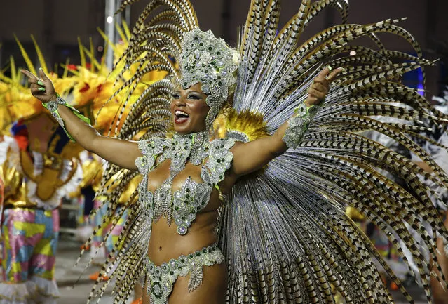 A dancer from the Academicos do Tucuruvi samba school performs during the Carnival parade at the Sambodromo in Sao Paulo, Brazil, Friday, February 13, 2015. (Photo by Andre Penner/AP Photo)
