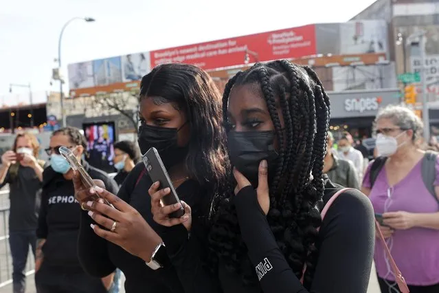 Kimora Miller and Shamyia Brown (both 18) hold their phones as the verdict is announced, at the Barclays Center in Brooklyn, New York City, New York, April 20, 2021. (Photo by Jeenah Moon/Reuters)