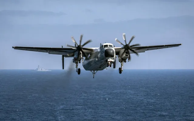 In this August 22, 2017, file photo provided by the U.S. Navy, a C-2A Greyhound assigned to the Providers of Fleet Logistics Support Squadron (VRC) 30, prepares to land on the flight deck aboard the aircraft carrier USS Theodore Roosevelt (CVN 71). The U.S. Navy has located a transport aircraft deep on the Pacific Ocean floor where it crashed in November, killing three sailors on board. The C-2A Greyhound aircraft, which was traveling to the aircraft carrier USS Ronald Reagan when it crashed the day before Thanksgiving in the Philippine Sea, rests at a depth of about 18,500 feet (5,640 meters), the Japan-based 7th Fleet said in a statement Saturday, Jan. 6, 2018. (Photo by Mass Communication Specialist 3rd Class Alex Corona/U.S. Navy via AP Photo)