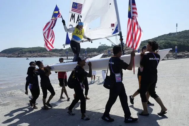 Nur Shazrin Binti Mohamad Latif of Malaysia celebrates her gold medal with her team members after women's Single Dinghy – ILCA6 class final race at Ningbo Xiangshan Sailing Center at the 19th Asian Games in Ningbo, China, Wednesday, September 27, 2023. (Photo by Eugene Hoshiko/AP Photo)