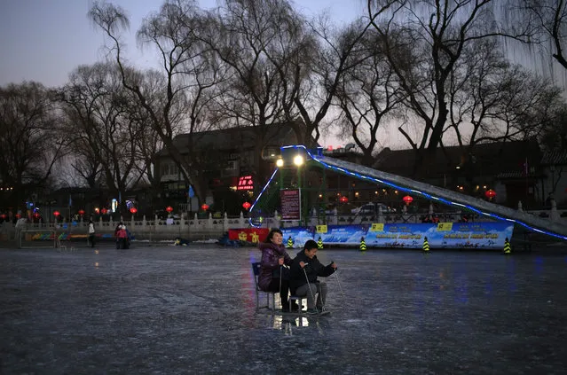 A woman and her son ride a sled on the frozen Shichahai lake in Beijing, China, 26 January 2016. While temperatures in Beijing have risen from a low of minus 17 degrees Celsius over the weekend, many areas in China still experience extreme cold weather as the polar vortex that brought freezing temperatures to the northern parts of China for the past week moved south, affecting provinces like Sichuan, Zhejiang, Fujian, Guangdong and Yunnan. (Photo by How Hwee Young/EPA)