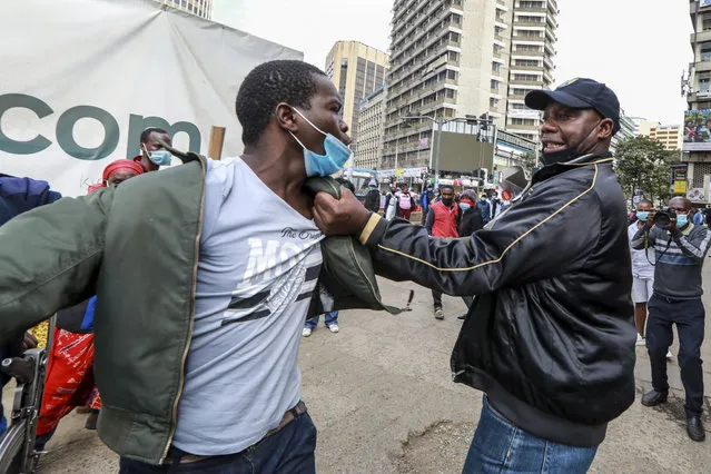 Kenyan activists (L) resist arrest from police officers, as police chased after activists from different social justice centers based in informal settlements, who were marching in protest against police brutality and harassment in their communities on Sab’a Sab’a day (or Seven-Seven), in Nairobi, Kenya, 07 July 2021. (Photo by Daniel Irungu/EPA/EFE)