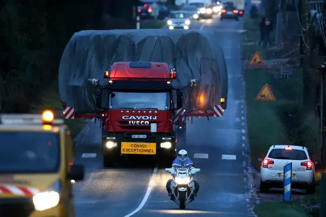 A special convoy transporting a lid that is to be installed on the vessel of the nuclear reactor EPR, currently under construction at Flamanville, drives on a highway in Marseille-en-Beauvaisis, northern France on February 10, 2016. The convoy transporting the lid of110 tons that measures 5,5 meters in diameter left the Areva plant on Chalon-sur-Saône, eastern France, on the morning of February 8 and is expected to arrive at its destination on February 11 or 12, Areva and EDF confirmed. (Photo by Charly Triballeau/AFP Photo)
