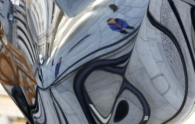 Joseph Hoare (11) is seen reflected as he poses for a photograph next to a Frank Stella sculpture on display in the courtyard of the Royal Academy, central London, February 18, 2015. Standing at 7 metres tall and 8 metres wide, entitled “Inflated Star and Wooden Star, 2014” it is the first time the piece has been exhibited in the UK and will be on display until the 17 May 2015. (Photo by Paul Hackett/Reuters)