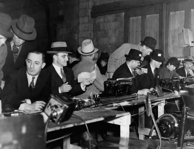 Newsmen in the press room in the prison garage are shown after Bruno Richard Hauptmann's execution in the electric chair, April 3, 1936. (Photo by John Lindsay/AP Photo)