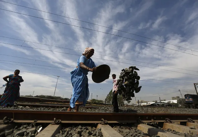 A labourer works on a railway track during repairs and maintenance of the tracks in Ahmedabad, India, February 24, 2016. (Photo by Amit Dave/Reuters)