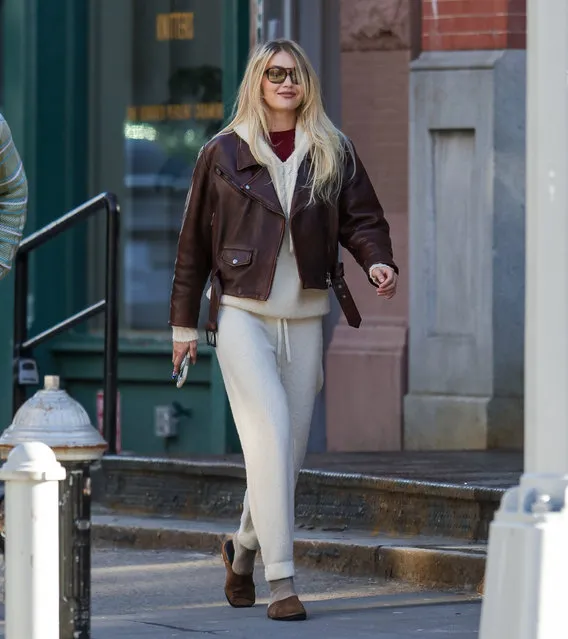 Gigi Hadid is spotted getting a flower delivery on Valentine's Day in New York City on February 14, 2024. The 28 year old American fashion model, who has been recently linked to Bradley Cooper wore a pair of beige joggers paired with a matching jumper and a leather jacket. Gigi arrived home as he bodyguard was taking delivery of a large bouquet of roses. (Photo by The Image Direct)