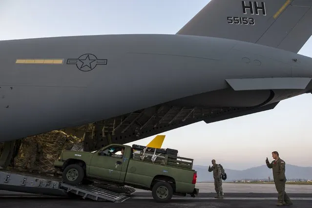 A vehicle is unloaded from an U.S. Air Force C-17A Globemaster III aircarft after it landed at Tribhuvan International in Kathmandu, Nepal, May 5, 2015. (Photo by Athit Perawongmetha/Reuters)