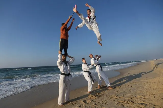 Palestinian youth show their skills as they practice taekwondo on the Mediterranean shore, in Khan Younis in the southern Gaza Strip on January 25, 2023. (Photo by Ibraheem Abu Mustafa/Reuters)