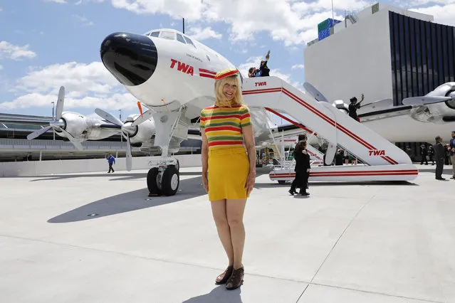 Susan Meekma Stevens, who was hired as a TWA stewardess in 1970, poses for photos in front of a Lockheed Constellation outside the newly opened TWA Hotel at New York's John F. Kennedy International Airport, Wednesday, May 15, 2019. (Photo by Mark Lennihan/AP Photo)