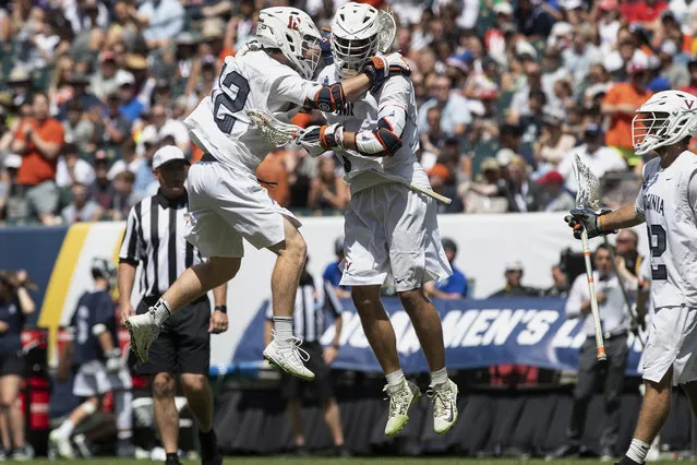 Virginia's Jack Simmons (12) congratulates Matt Moore after scoring in the fourth quarter of a game against Yale in the NCAA college lacrosse championship in Philadelphia on Monday, May 27, 2019. Virginia beat defending champion Yale, 13-9, in the national title game Monday. (Photo by Jose F. Moreno/The Philadelphia Inquirer via AP Photo)