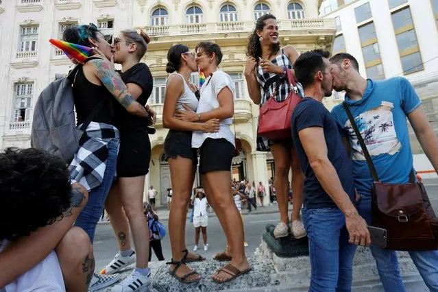 Cuban LGBT activists kiss each other while participating in an annual demonstration against homophobia and transphobia in Havana, Cuba, Saturday, May 11, 2019. CENESEX, headed by Mariela Castro, the daughter of Communist Party leader Raul Castro, said in a statement that certain groups were planning to use the event to undermine the government, emboldened by the escalation of aggression by the Trump administration against Cuba and its leftist ally Venezuela. The United States has for decades financed often covert programs to promote democracy on the island and undermine the Communist government. (Photo by Reuters/Stringer)