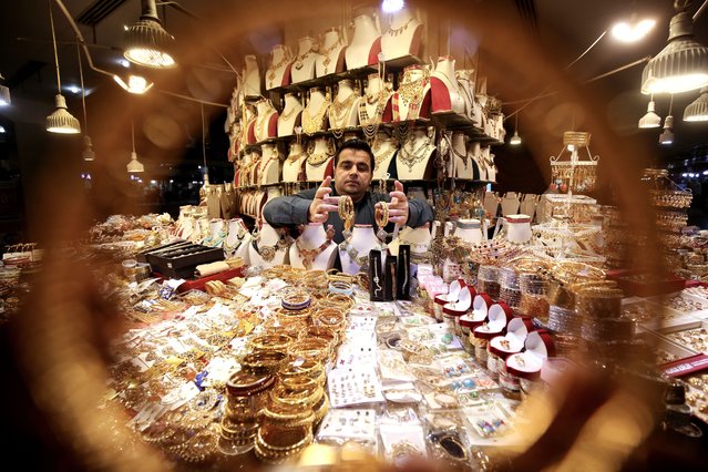 A Pakistani vendor sells bracelets at a jewelry store ahead of the Eid al-Fitr holiday, in Peshawar, Pakistan, 08 April 2024. The Islamic holiday of Eid al-Fitr marks the end of Ramadan and is celebrated during the first three days of Shawwal, the 10th month of the Islamic calendar. It is expected to begin on 10 or 11 April 2024, depending on the lunar calendar. The Muslims' holy month of Ramadan is the ninth month in the Islamic calendar and it is believed that the revelation of the first verse in the Koran was during its last 10 nights. It is celebrated yearly by praying during the night time and abstaining from eating, drinking, and sexual acts during the period between sunrise and sunset. It is also a time for socializing, mainly in the evening after breaking the fast and a shift of all activities to late in the day in most countries. (Photo by Arshad Arbab/EPA/EFE)