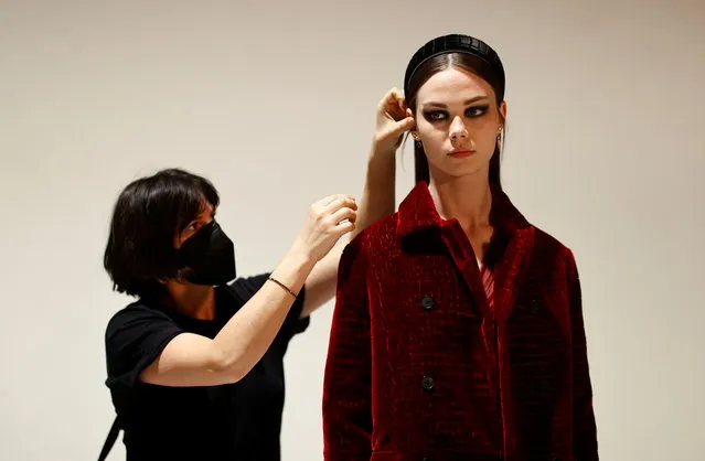 A model wearing a creation by designer Maria Grazia Chiuri for fashion house Dior poses during an interview with Reuters ahead of her Fall/Winter 2021 collection presentation in a digital format during Paris Fashion week, in Aubervilliers, near Paris, France, March 6, 2021. (Photo by Christian Hartmann/Reuters)