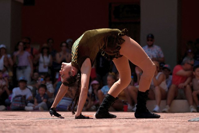 A member of the Yabisi Circus of Puerto Rico performs during Puerto Rico Circo Fest in Old San Juan, Puerto Rico on March 11, 2023. (Photo by Ricardo Arduengo/Reuters)