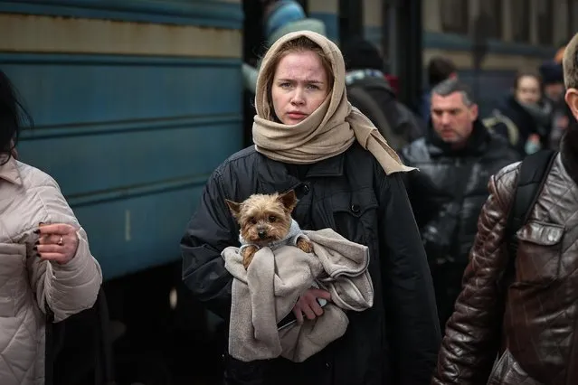 A Ukrainian woman with her dog, who was forced to leave the city under Russian attacks, experiences the hardest International Women's Day far away from her home in Kyiv, Ukraine on March 06, 2022. Ukrainians did not leave their pets behind despite their difficult journeys, while they were evacuated to the safe points. (Photo by Emin Sansar/Anadolu Agency via Getty Images)