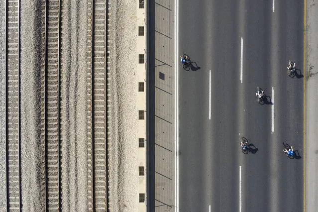 Young kids ride their bicycles on a car-free highway, during the Jewish holiday of Yom Kippur in Tel Aviv, Israel, Wednesday, October 9, 2019. Israelis are marking Yom Kippur, or “Day of Atonement”, which is the holiest of Jewish holidays when observant Jews atone for the sins of the past year and the Israeli nation comes to almost a complete standstill. Many residents take bicycles onto the streets as no traffic is permitted on the roads. (Photo by Oded Balilty/AP Photo)