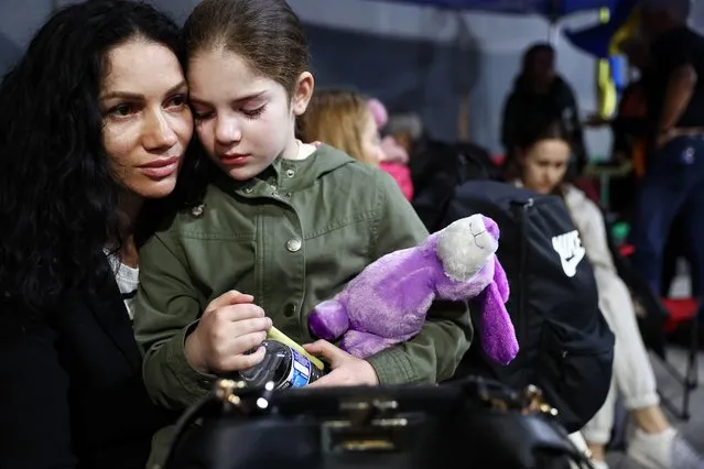 A Ukrainian mother and daughter, who are seeking asylum in the U.S., wait to cross the U.S.-Mexico border at the San Ysidro Port of Entry amid the Russian invasion of Ukraine on April 5, 2022 in Tijuana, Mexico. The mother and daughter fled their home city of Kharkiv on March 1st. U.S. authorities are allowing Ukrainian refugees to enter the U.S. at the Southern border in Tijuana with permission to remain in the country on humanitarian parole for one year. (Photo by Mario Tama/Getty Images)