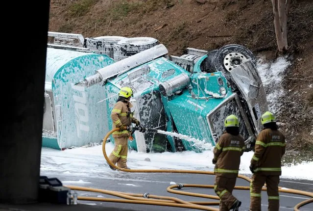 Emergency services attend to a fuel tanker crash on the Calder Freeway in Keilor East, in Melbourne's north-west, Australia, 24 May 2016. Six people are in hospital and one may have died after a petrol tanker rolled, crushing a car and starting a chain of collisions on a Melbourne freeway. (Photo by Joe Castro/EPA)