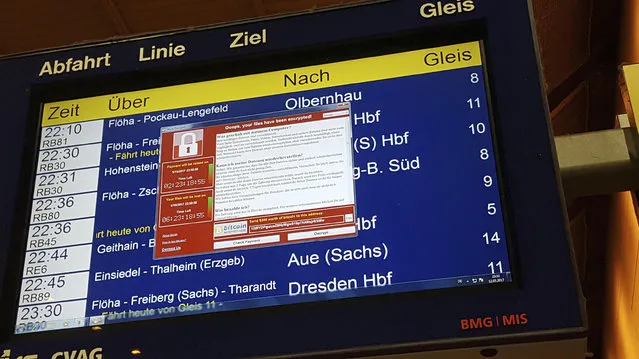 In this May 12, 2017 photo, a display panel with an error can be seen at the main railway station in Chemnitz, Germany. Germany’s national railway says that it was among the organizations affected by the global cyberattack but there was no impact on train services. Deutsche Bahn said early Saturday that departure and arrival display screens at its stations were hit Friday night by the attack. (Photo by P. Goezelt/DPA via AP Photo)